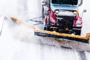 Snowplow removing the Snow from Highway during a Snowstorm
