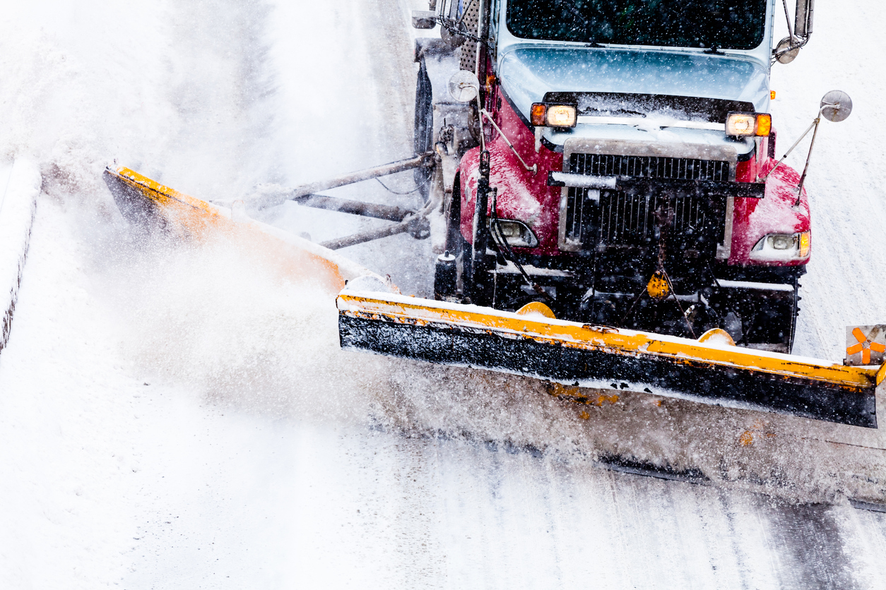 Snowplow removing the Snow from Highway during a Snowstorm