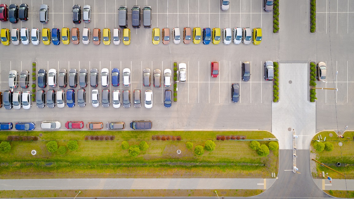Car parking lot viewed from above, Aerial view. Top view. Lots of vibrant car sunny day, dealership